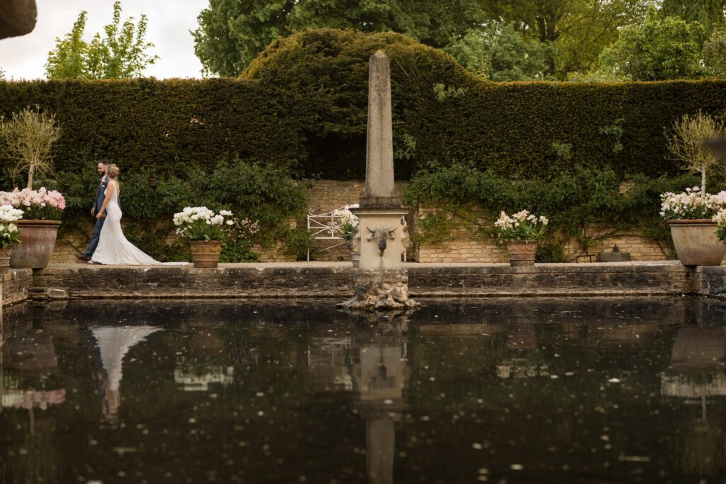 122 bride groom walk alone euridge manor ornamental lake chippenham wiltshire oxfordshire wedding photographer