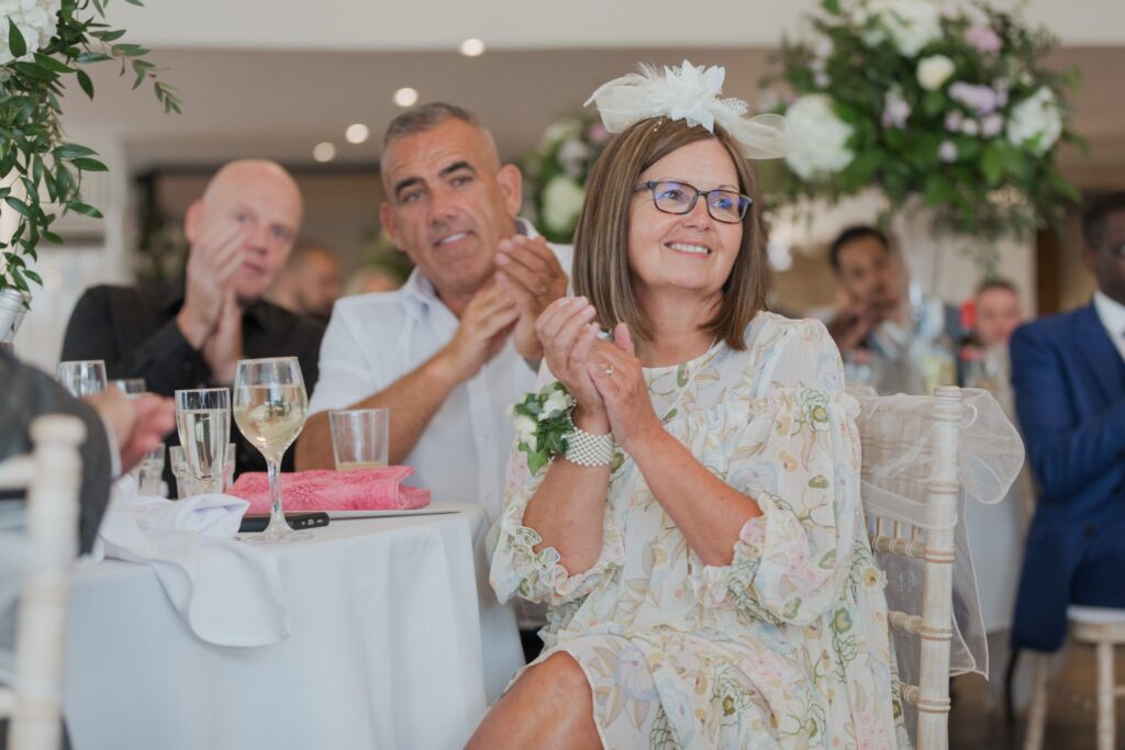 124 smiling guests applaud speaker cotswold hotel golf & spa reception oxfordshire wedding photographer