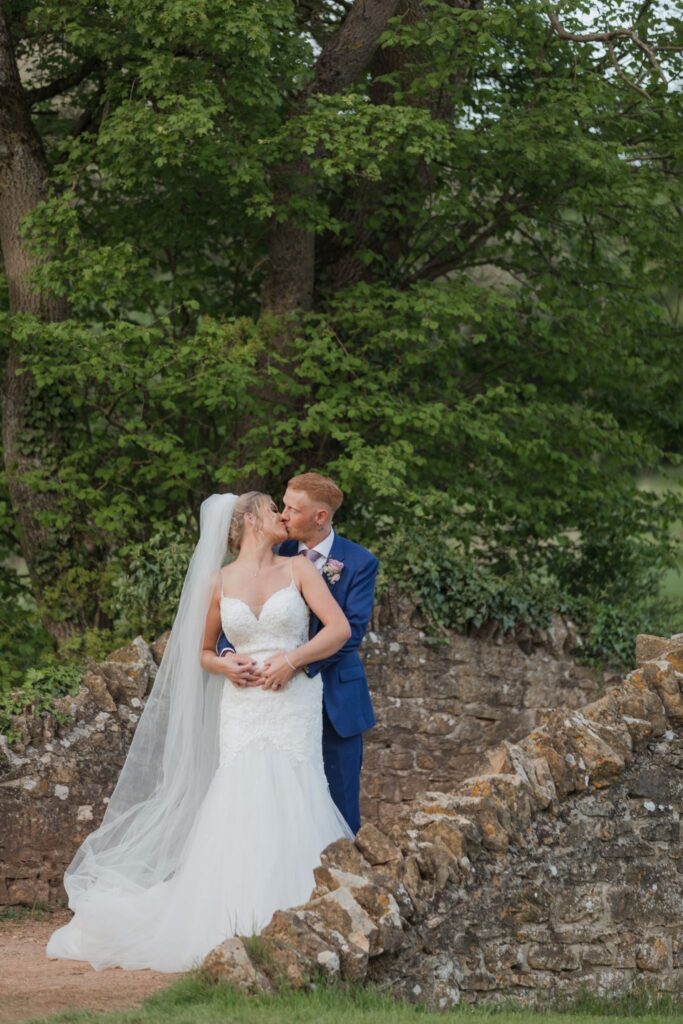 130 bride groom kiss cotswolds hotel stone bridge chipping norton oxfordshie wedding photographer