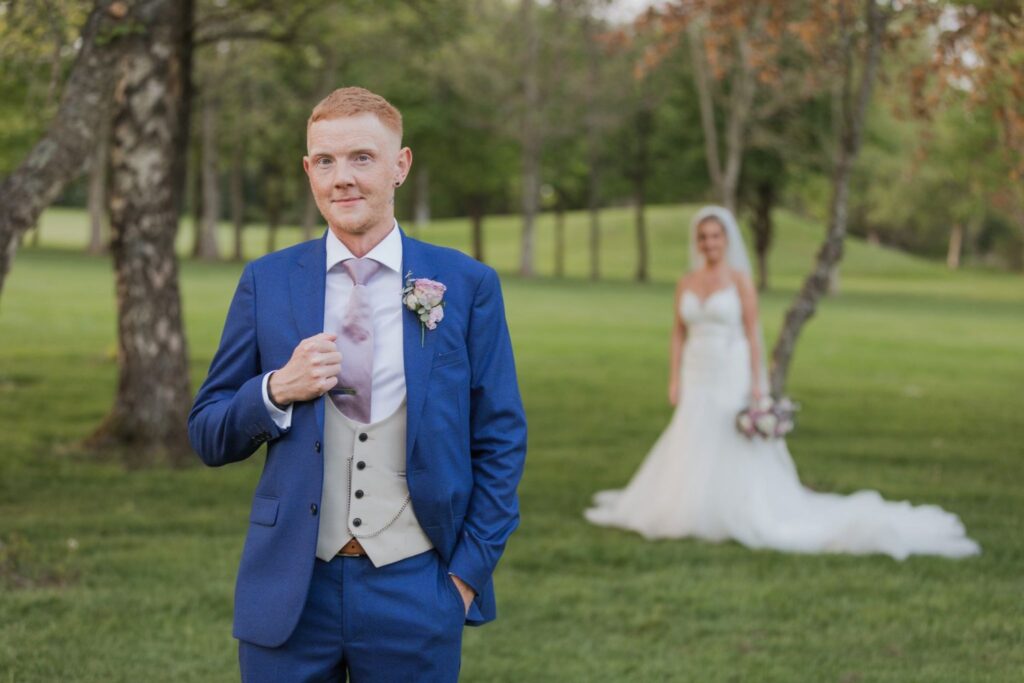 132 groom holds jacket lapel bride watches cotswolds hotel golf course chipping norton oxfordshire wedding photography