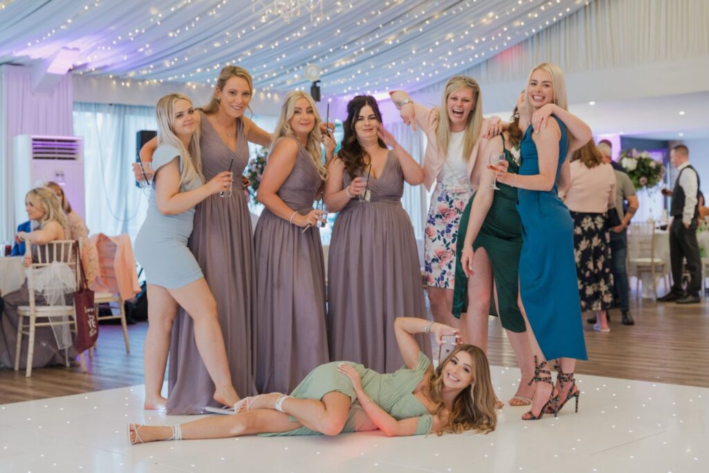 140 bridesmaid guests enjoy drinks reception cotswolds hotel marquee chipping norton oxfordshire wedding photographers