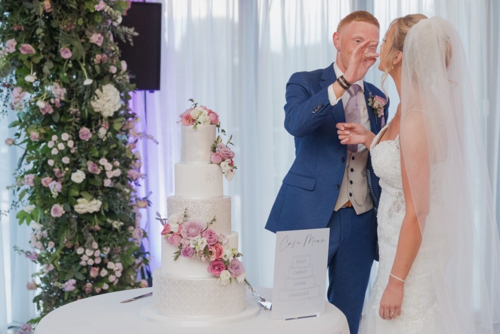 142 bride enjoys cake cotswolds hotel golf & spa chipping norton oxfordshire wedding photography