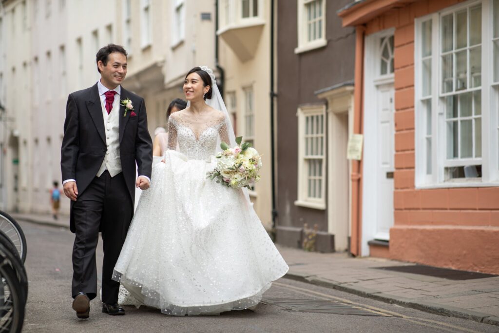 18 smiling bride groom stroll oxford city centre oxfordshire wedding photography