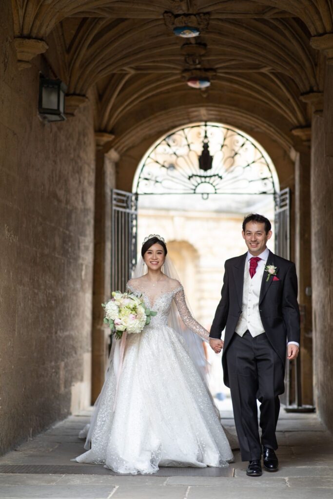 23 bride groom hold hands radcliffe camera oxford oxfordshire wedding photographers