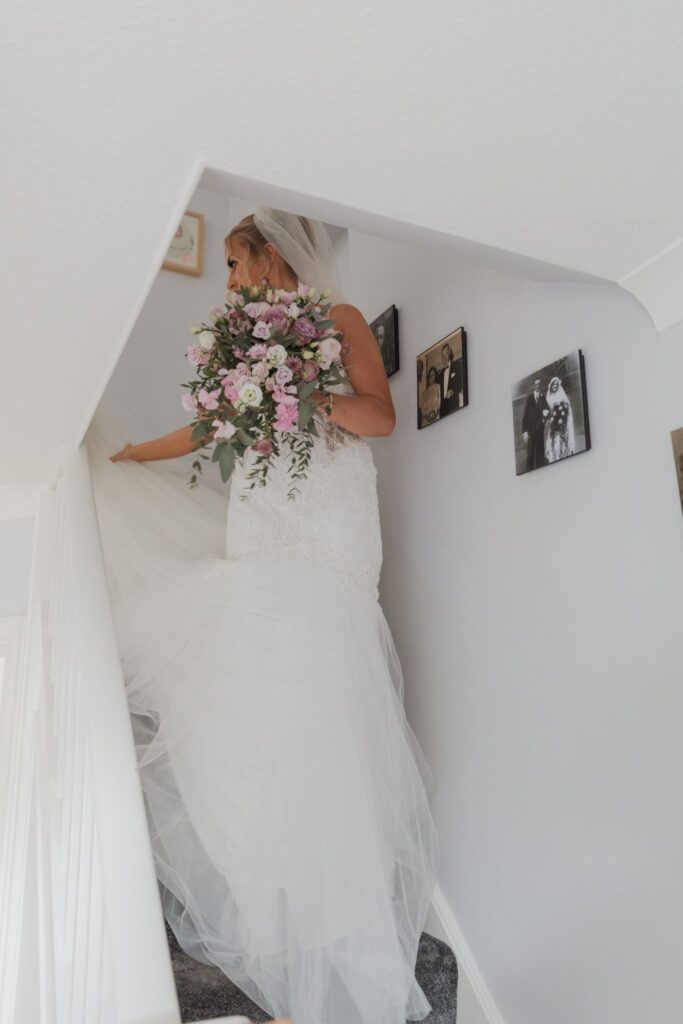 34 bride descends stairs bridal prep oxford oxfordshire wedding photographer