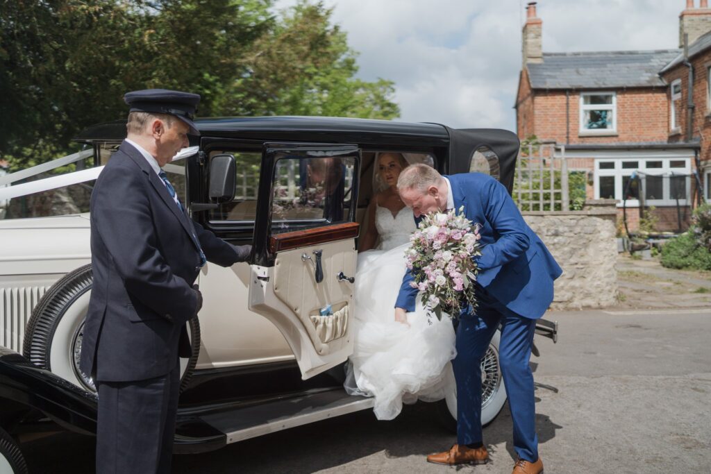 37 bride exits bridal car headington quarry parish church oxford oxfordshire wedding photographer