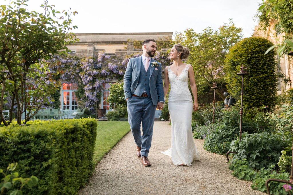 bride groom stroll holding hands euridge manor garden chippenham wiltshire oxford wedding photographer
