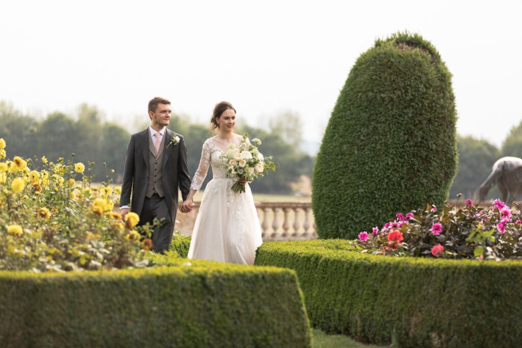 118 bride groom stroll together prestwold hall flower garden leicestershire oxford wedding photographer