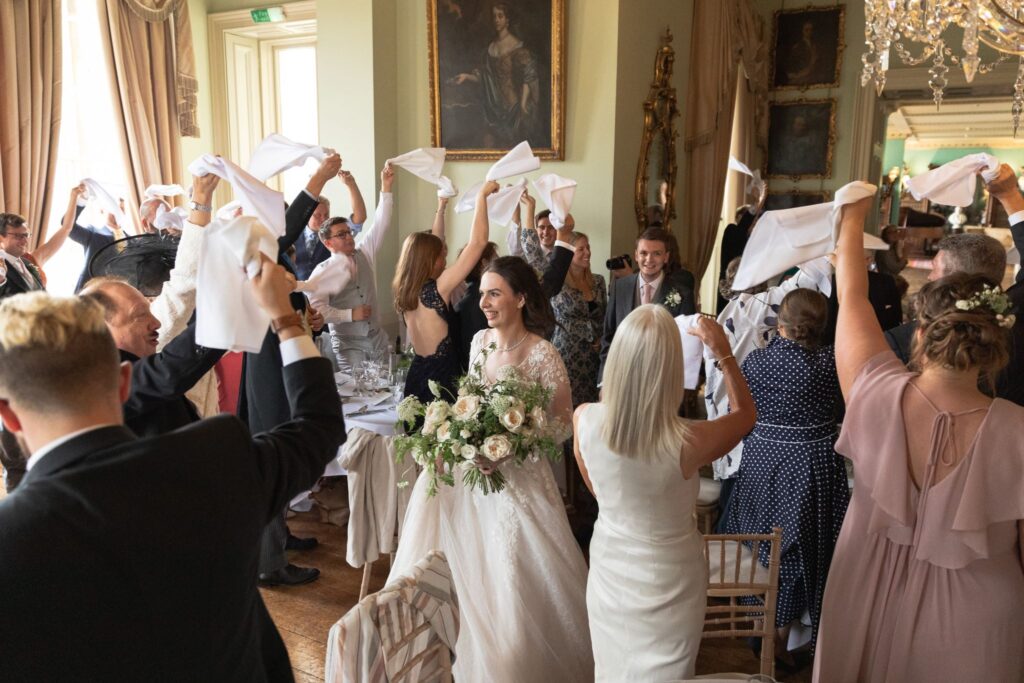 123 napkin waving guests welcome bride groom prestwold hall reception leicestershire oxfordshire wedding photography