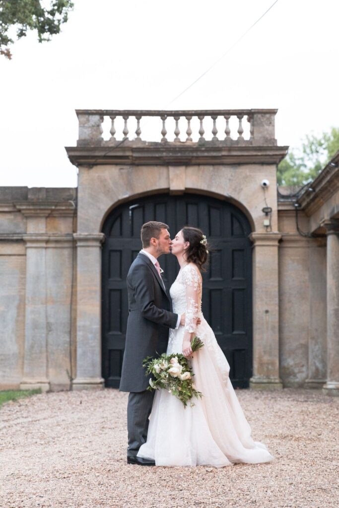 136 bride groom kiss prestwold hall courtyard leicestershire oxfordshire wedding photographers
