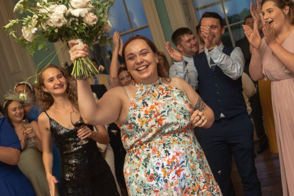 141 grinning guest catches brides bouquet prestwold hall tossing ceremony leicestershire oxfordshire wedding photography