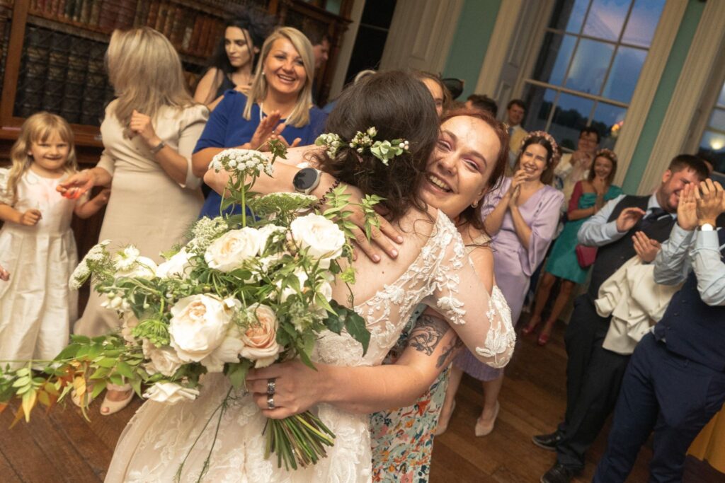 142 bride hugs bouquet catcher prestwold hall leicestershire oxford wedding photography