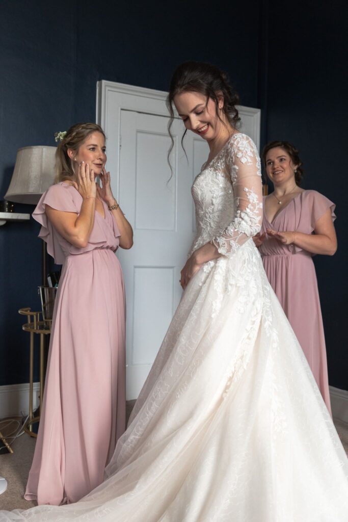 42 bridesmaids admire brides gown prestwold hall bridal prep loughborough oxford wedding photographers