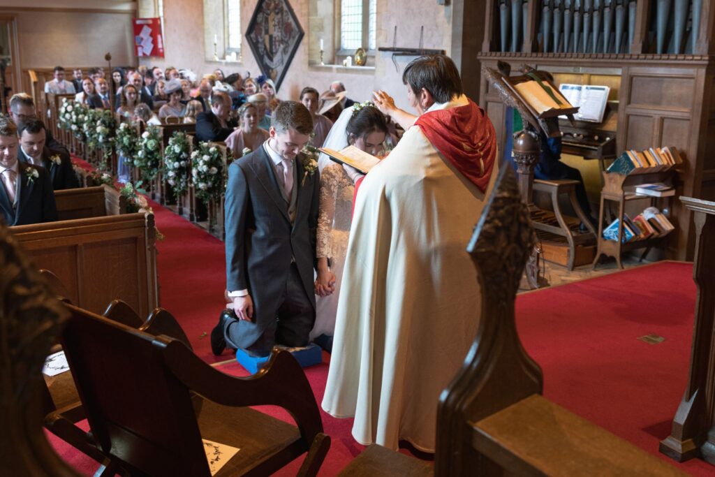 75 priest blesses bride groom st andrews church prestwold loughborough oxfordshire wedding photographer