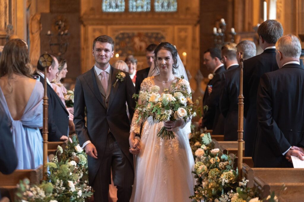 79 groom holds brides hand walking aisle st andrews church prestwold loughborough oxford wedding photographers