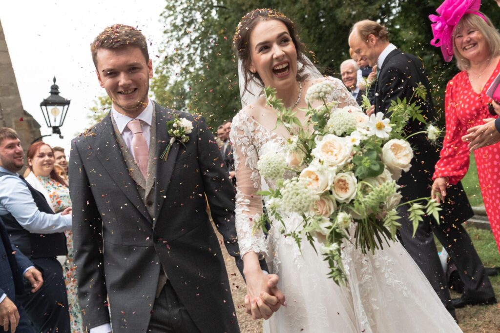 87 laughing bride grooms confetti shower st andrews church prestwold loughborough oxfordshire wedding photographer