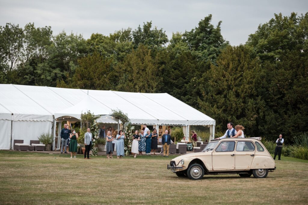 105 marquee guests watch bride grooms vintage car ride ardington house wantage oxfordshire wedding photographers