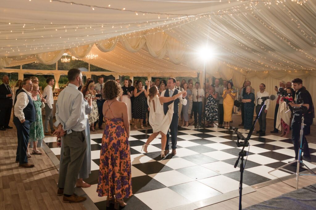 111 guests enjoy bride grooms first dance ardington house marquee reception wantage oxfordshire wedding photographers