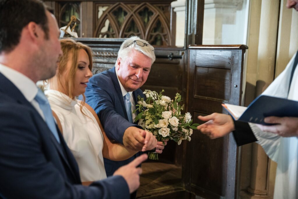 40 father of bride takes bouquet holy trinity church ceremony ardington wantage oxfordshire wedding photographerrs