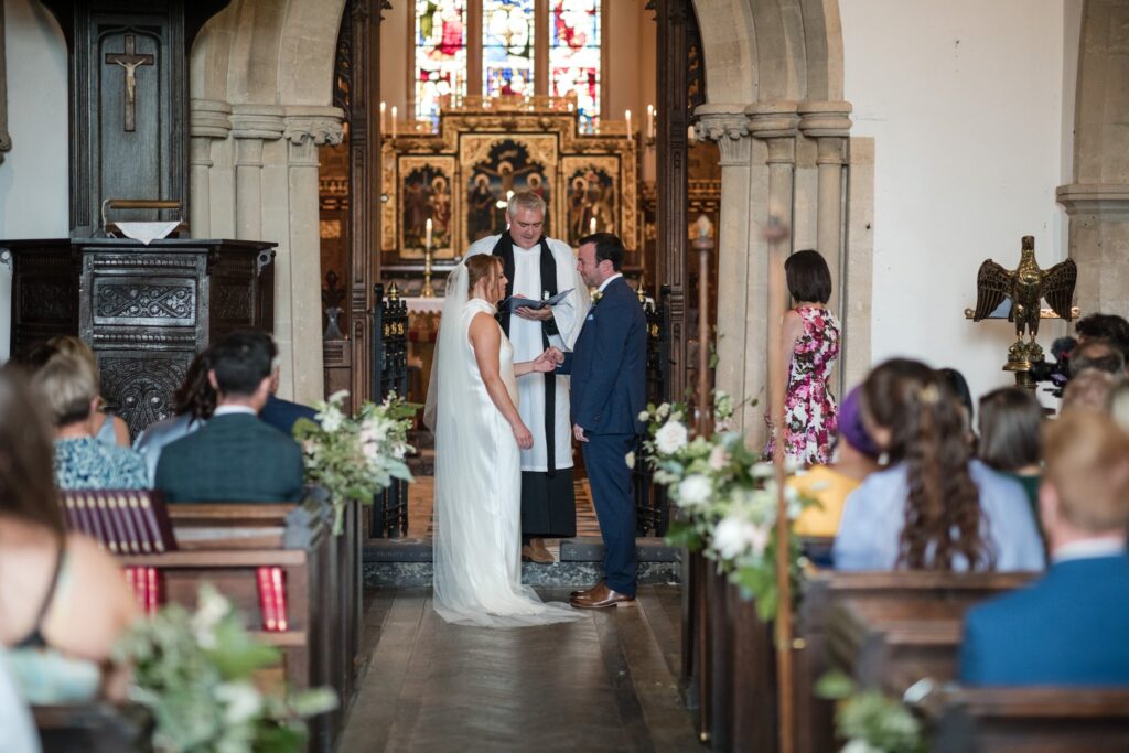 41 priest conducts marriage ceremony holy trinitty church ardington wantage oxfordshire wedding photography