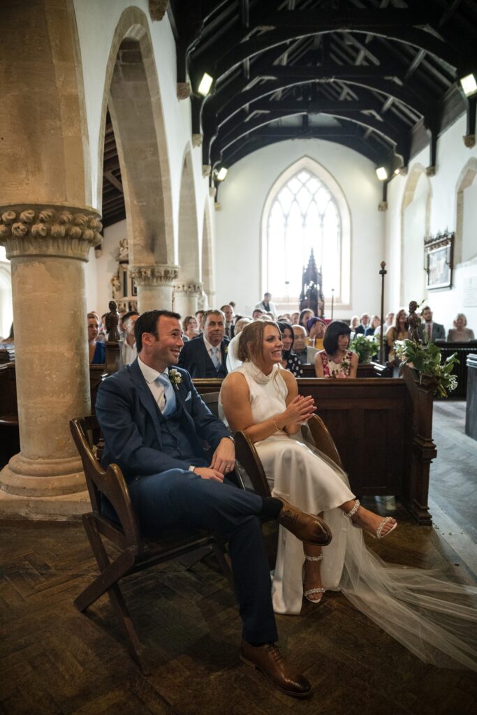 46 seated bride groom hear priest holy trinity church ardington wantage oxford wedding photographers