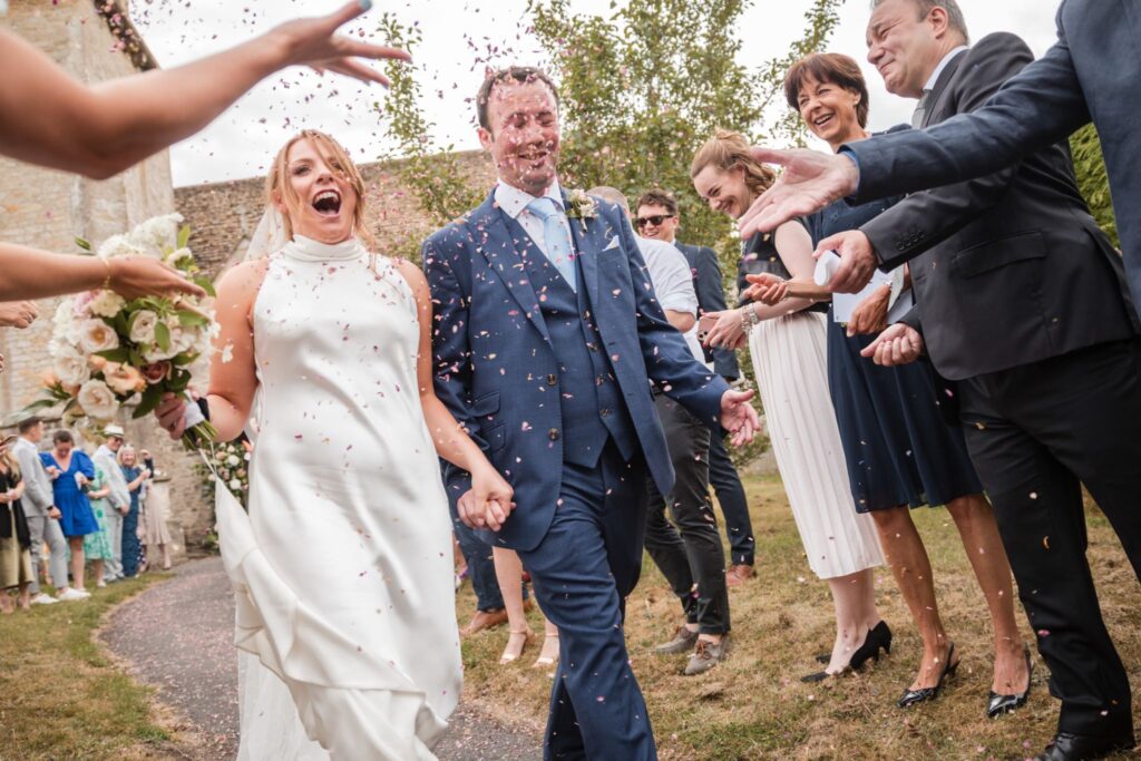 51 guests throw conetti holy trinity churchyard ardington wantage oxfordshire wedding photographer