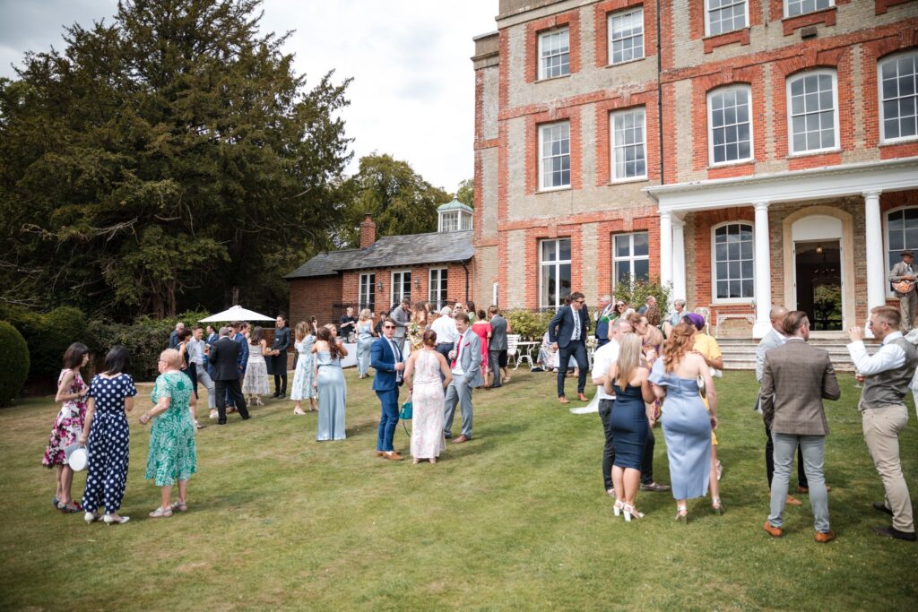 64 guests enjoy champagne reception ardington house lawn wantage oxfordshire wedding photography