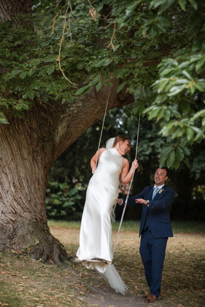 78 groom pushes brides swing ardington house grounds wantage oxfordshire oxford wedding photographers