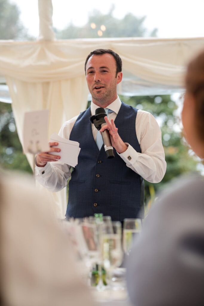95 groom holds microphone marquee reception speech wantage oxfordshire wedding photographers