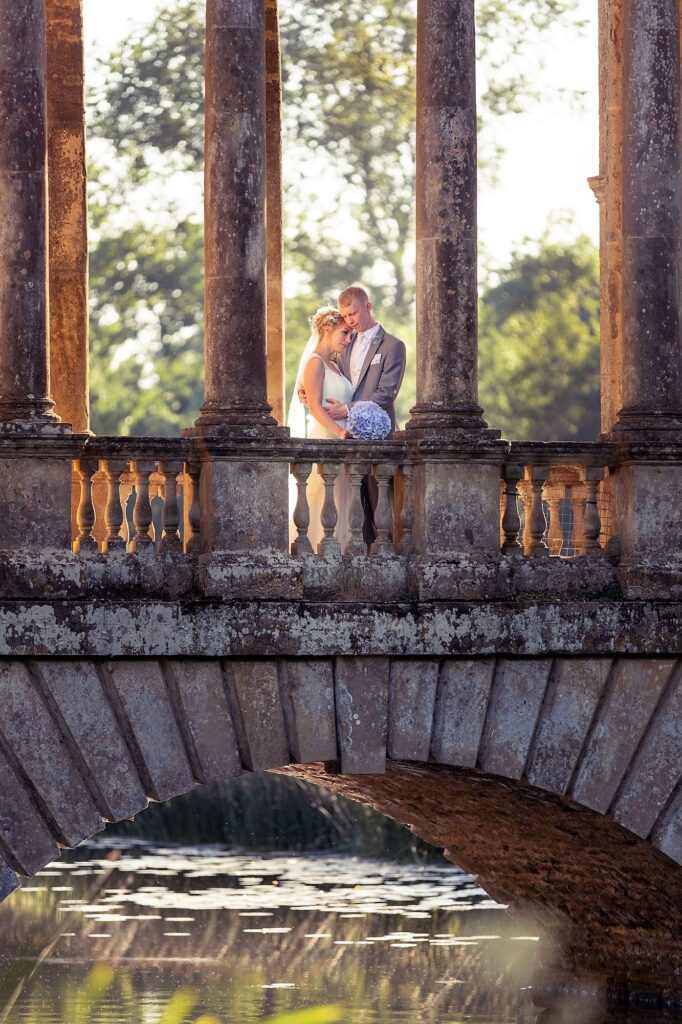 bride groom embrace stowe house stone bridge buckinghamshire oxford wedding photographers
