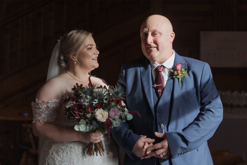 039 father of bride holds daughters hand rushpool hall saltburn north yorkshire oxford wedding photography